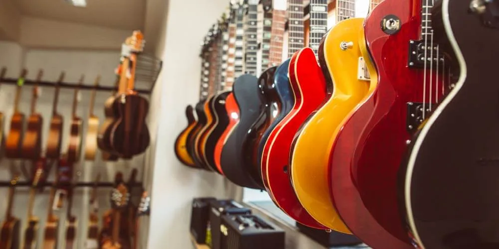 Guitars displayed in retail outlet with complete product information