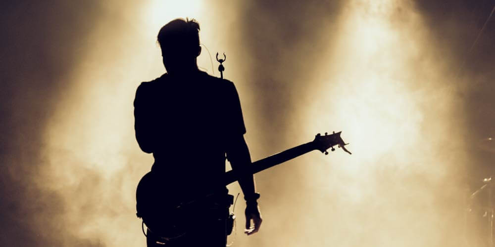 performer playing guitar on stage