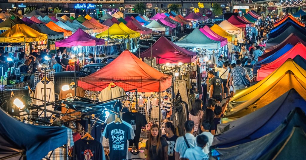 night market crowds in Bangkok, Thailand with colorful stalls