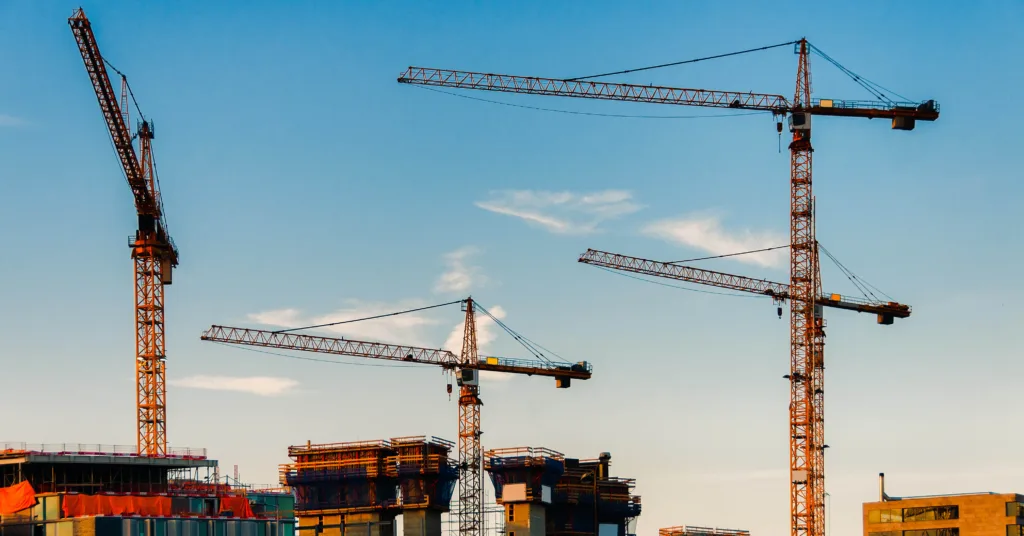 four cranes working on new construction