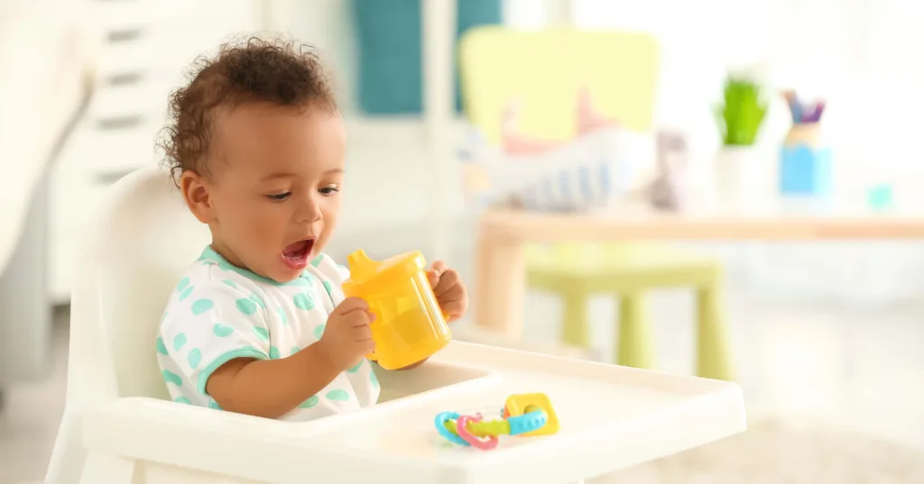 A baby eating sat in a highchair