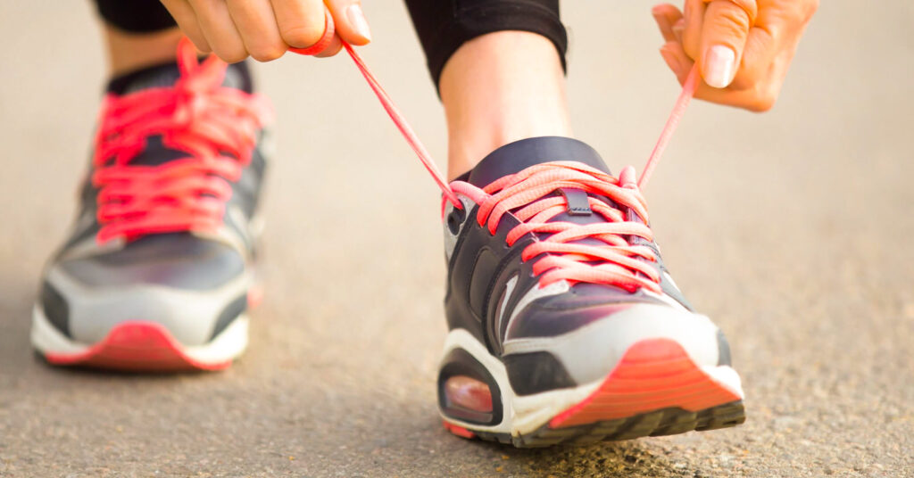 female runner tying her laces