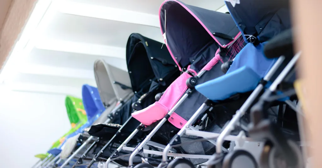Colourful baby strollers lined up in store