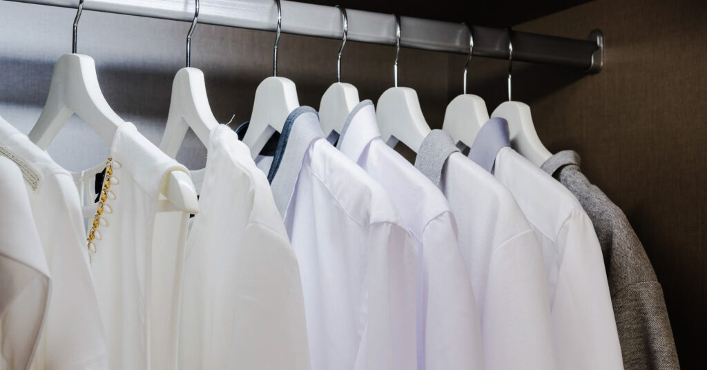 white clothes hanging in wardrobe