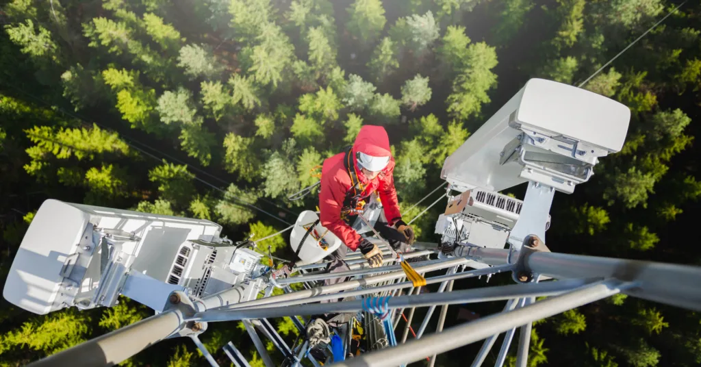 engineer working on cables high above treeline