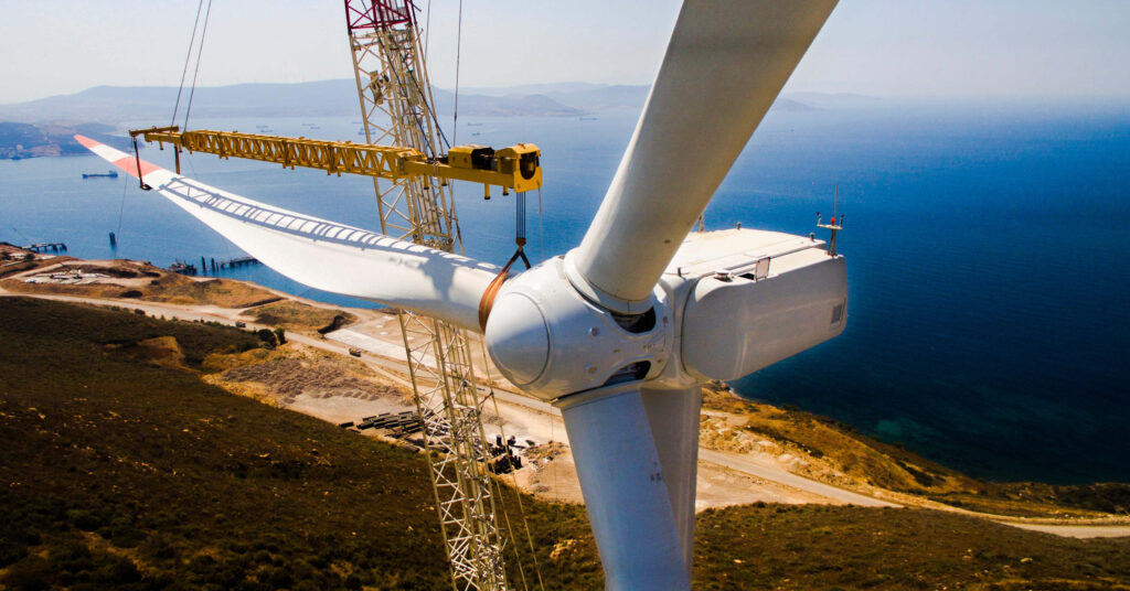 windmills being constructed along coastline