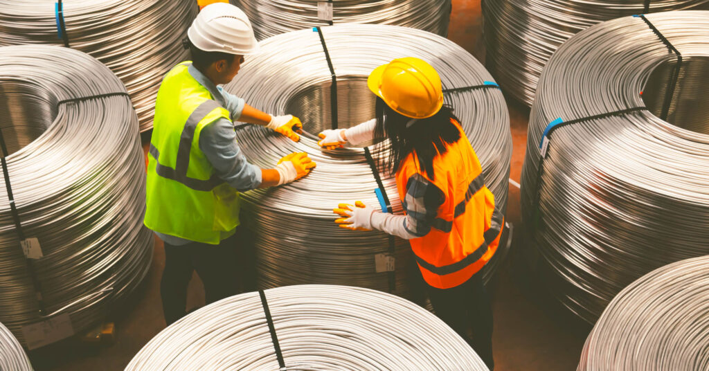 workers with large cable rolls