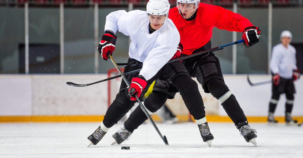 two ice hockey players in action on the ice