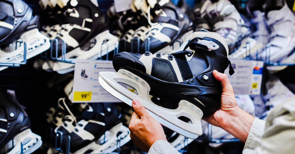 shopper comparing ice skates in sporting goods store