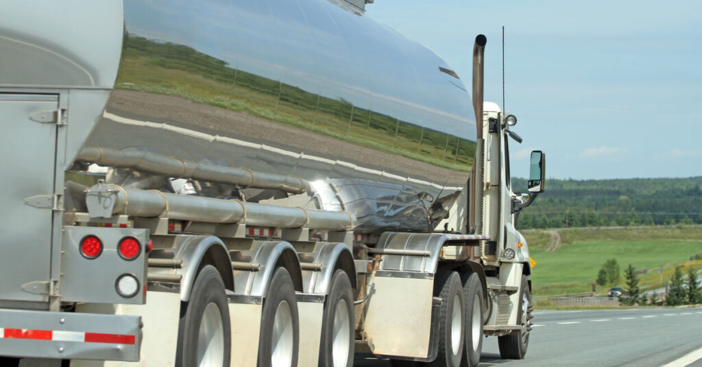 milk tanker driving down rural highway