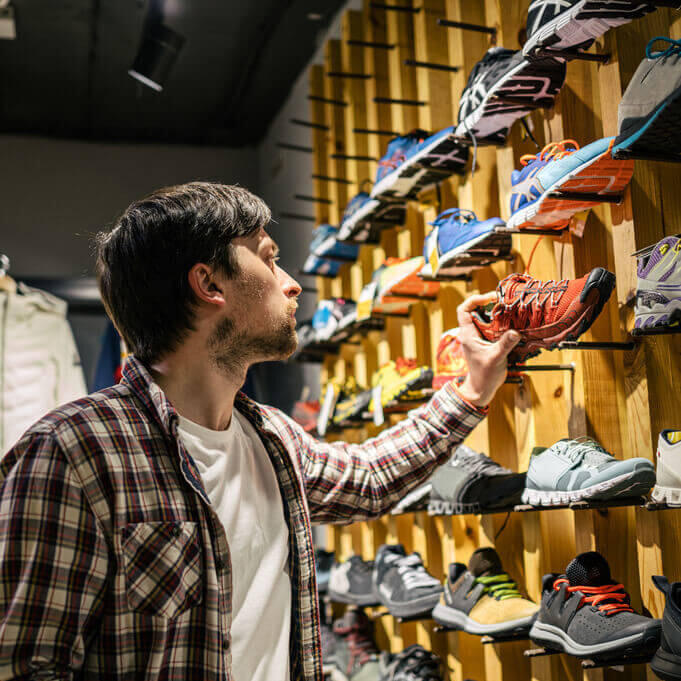man shopping for shoes in shoe store