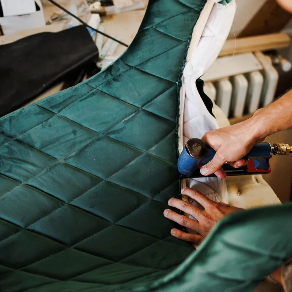 green padded chair being reupholstered