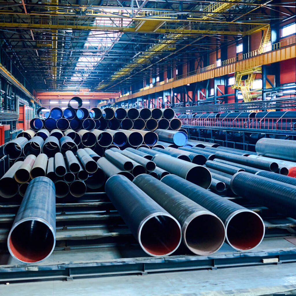 interior of industrial warehouse with large pipes on the floor