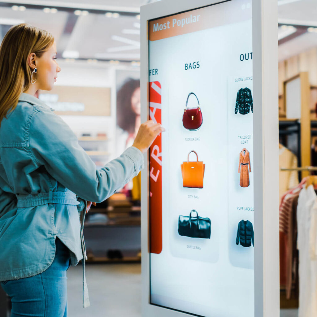 female shopper using digital product catalog in clothing store