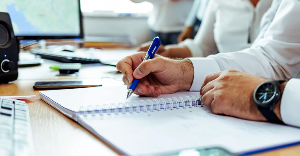 workers performing audit trails with pen and paper