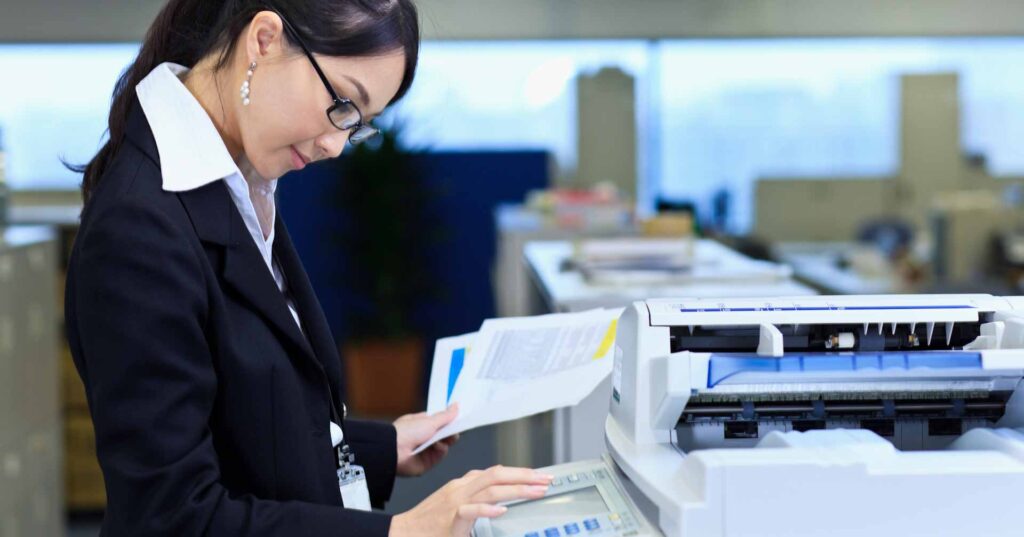Female office worker using copier