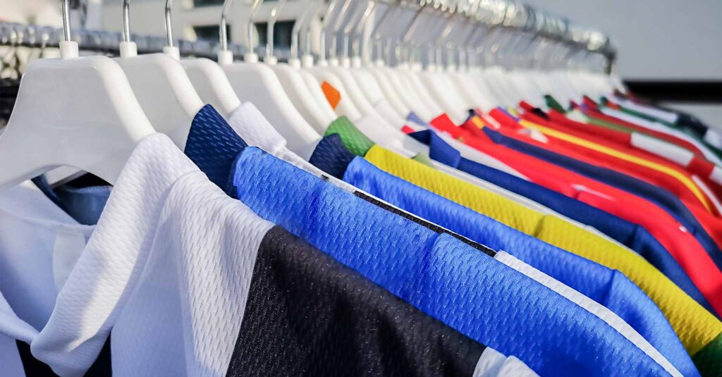 Colorful sports team shirts hanging at clothes rails
