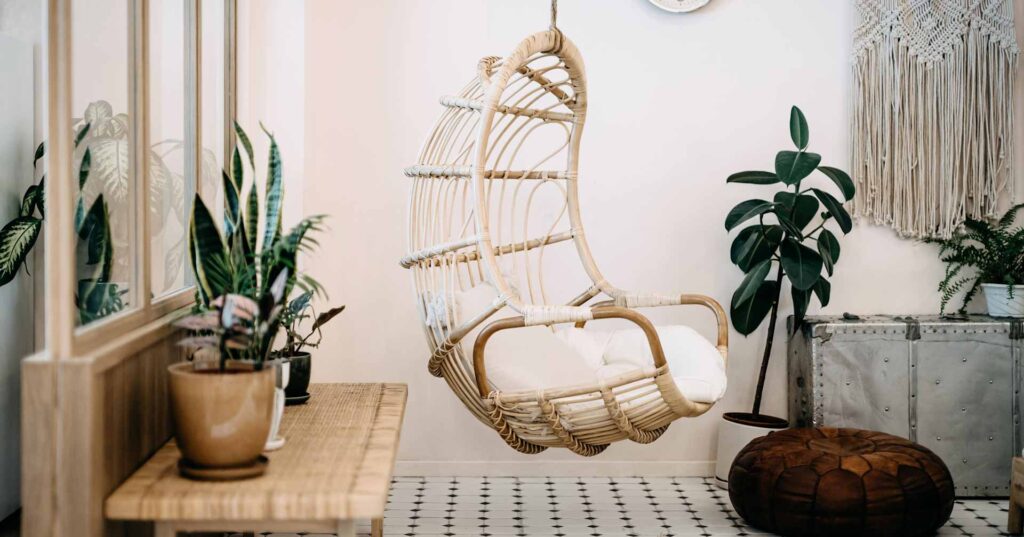 Cozy hanging chair in the loft living room with stylish and bohemia design. Well designed and decorated with an assortment of interesting plants