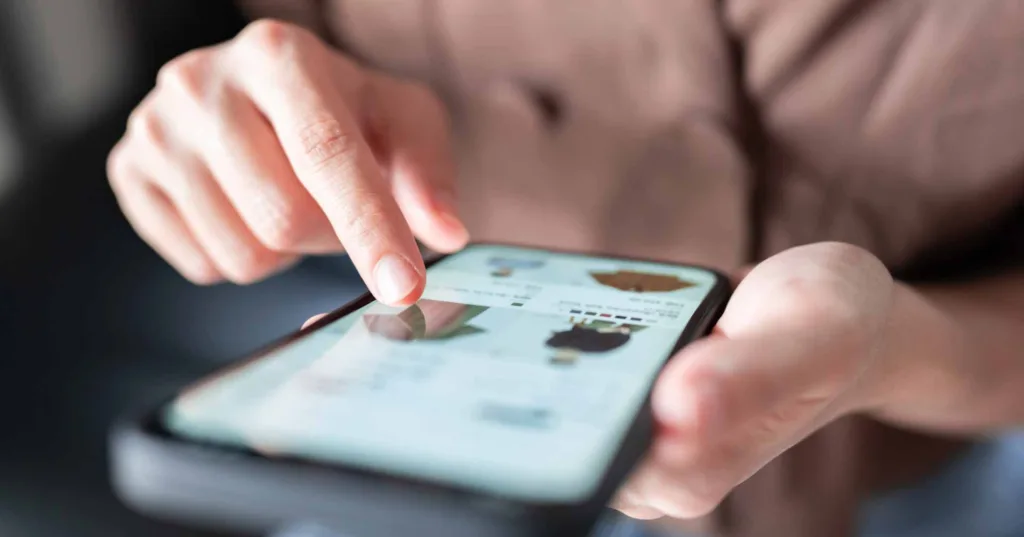 woman shopping for clothes on smart phone