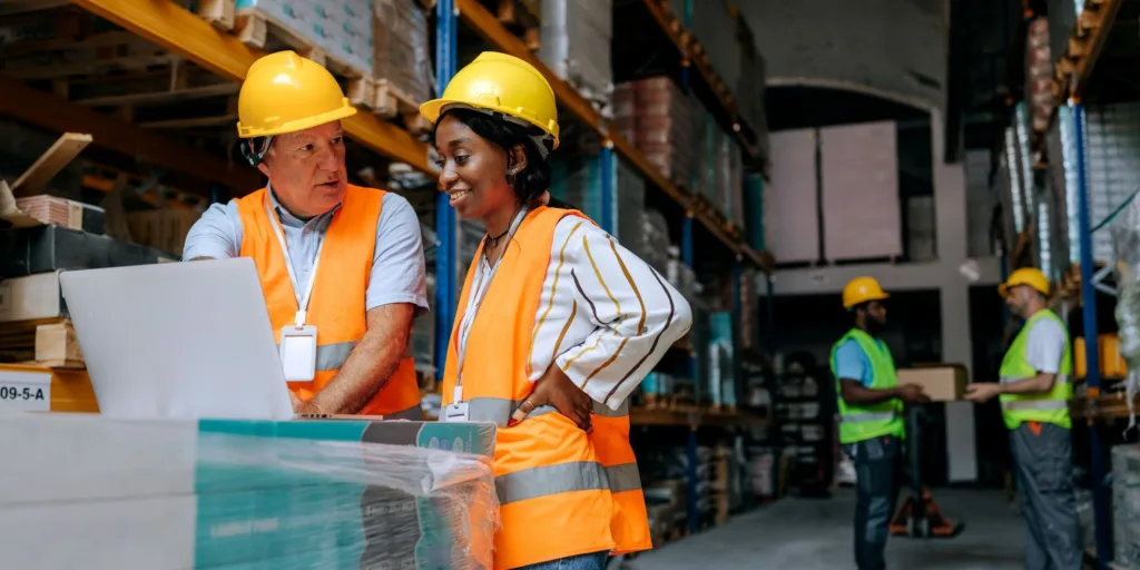 female and male workers in warehouse meeting