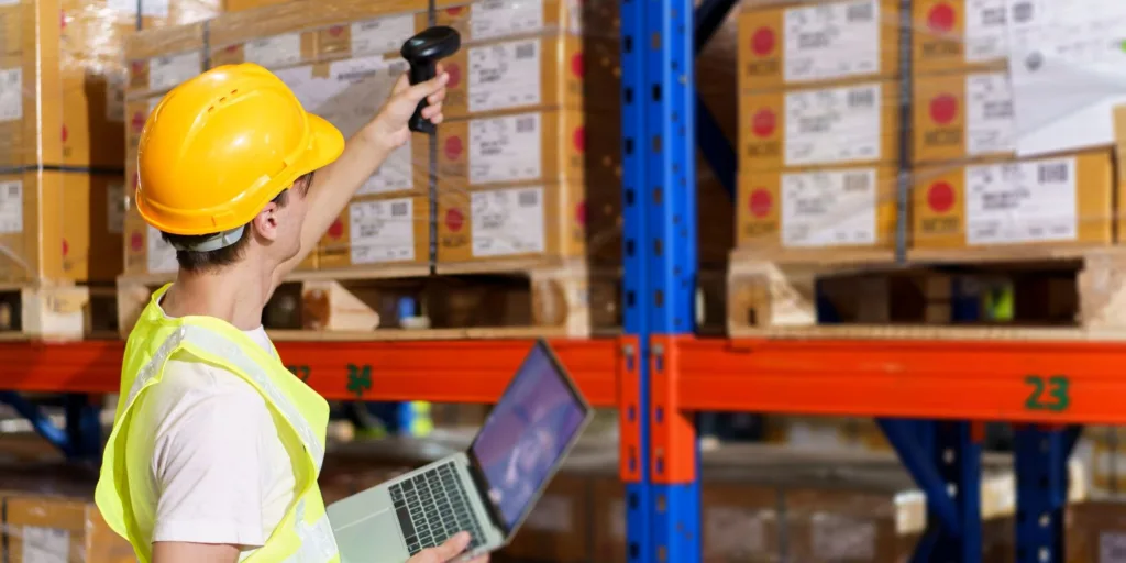 male warehouse worker scanning barcode