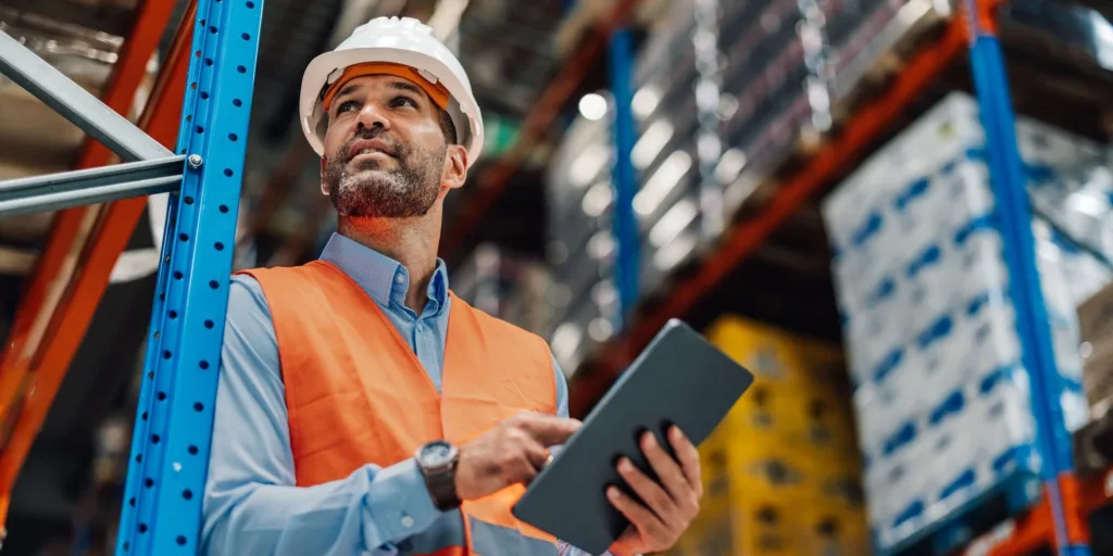 male warehouse employee holding a tablet