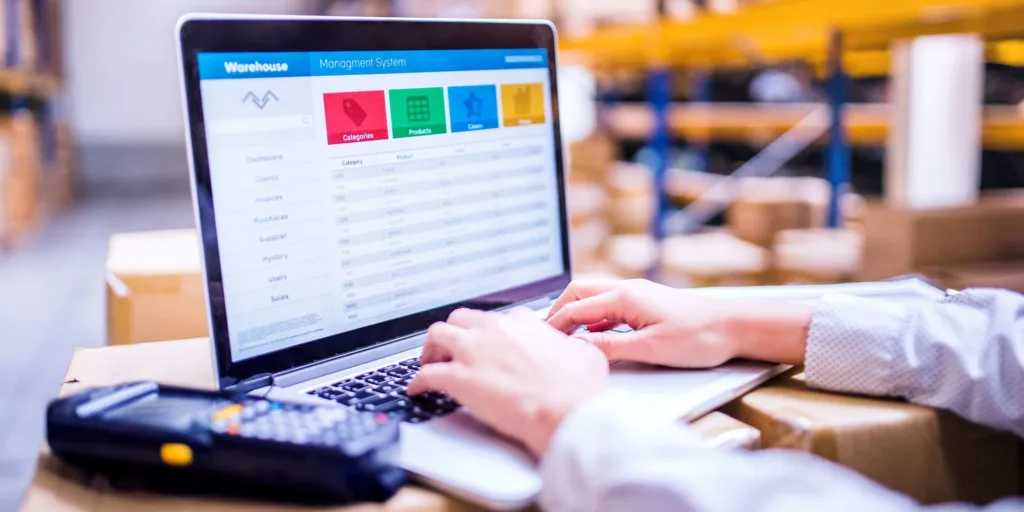 woman warehouse worker using laptop warehouse management